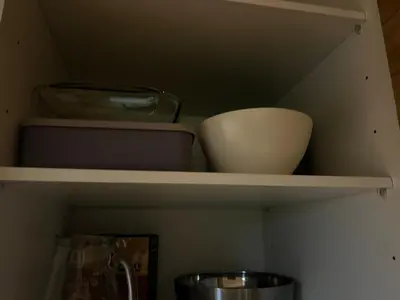 a shelf with bowls and other items on it at Beira Mar AB2 in Santa Maria