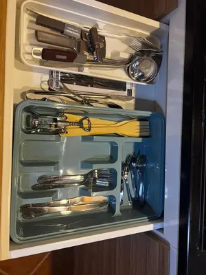 a drawer full of utensils in a cabinet at Beira Mar AB2 in Santa Maria