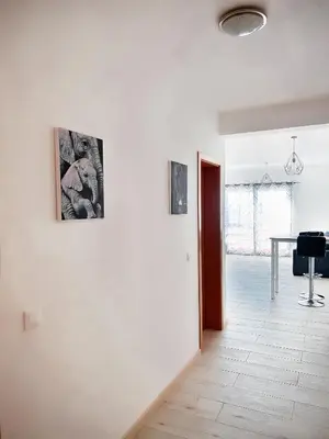 a living room with three pictures on the wall at P&SApartments in Santa Maria