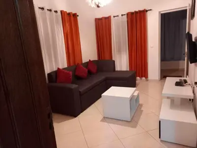 a living room with a black couch and red pillows at Black Diamond - CASA Tia Bia in Ribeira Grande