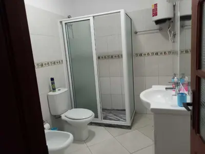 a bathroom with a shower and a toilet and a sink at Black Diamond - CASA Tia Bia in Ribeira Grande