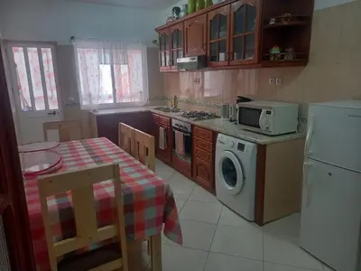 a kitchen with a table and a stove and a microwave at Black Diamond - CASA Tia Bia in Ribeira Grande
