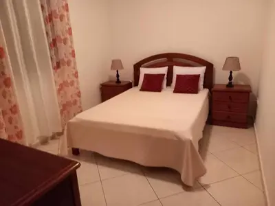 a bedroom with a bed with two night stands and two lamps at Black Diamond - CASA Tia Bia in Ribeira Grande