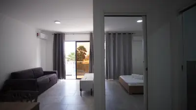 a living room with a couch and a bed at Atlantico Sal Apt in Santa Maria
