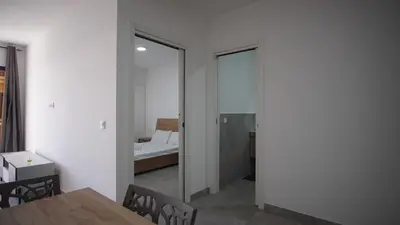 a room with white walls and a table and a mirror at Atlantico Sal Apt in Santa Maria