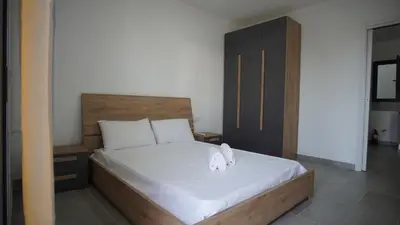a bedroom with a bed with two towels on it at Atlantico Sal Apt in Santa Maria