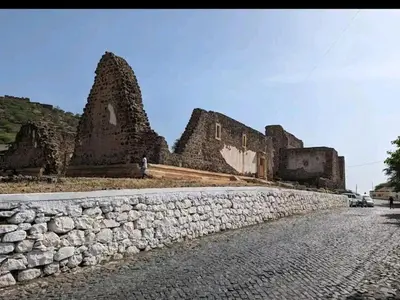 a stone wall in front of a building at Get house kira in Cidade Velha
