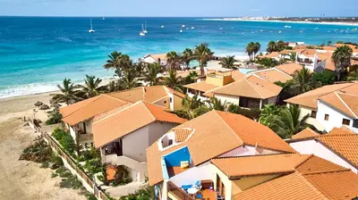 an aerial view of a beach with houses and the ocean at T1 Vista Mar - Porto Antigo 3 in Santa Maria