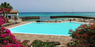a large blue swimming pool next to the ocean at T1 Vista Mar - Porto Antigo 3 in Santa Maria