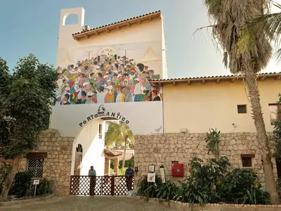 a building with a large mural on the side of it at T1 Vista Mar - Porto Antigo 3 in Santa Maria