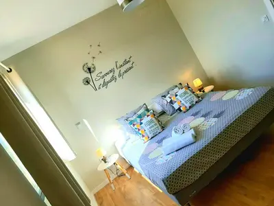 a bedroom with a bed with a blue comforter at Morabeza Deluxe view on the sea in Mindelo