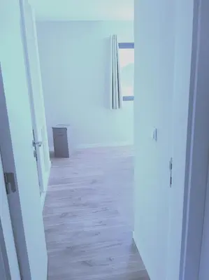a hallway with a door open to a room with a window at Morabeza Deluxe view on the sea in Mindelo