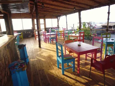 a restaurant with colorful tables and chairs in a room at Casa De France in Porto Novo