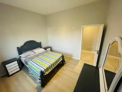 a bedroom with a bed with a colorful blanket on it at Aparthotel Pilon T3 in Praia