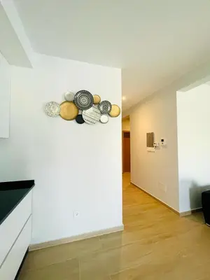 a room with a white wall with vegetables on it at Aparthotel DI LIA T3 in Praia