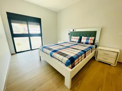 a bedroom with a bed and a dresser and a window at Aparthotel DI LIA T3 in Praia