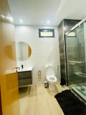 a bathroom with a shower and a toilet and a sink at Aparthotel DI LIA T3 in Praia