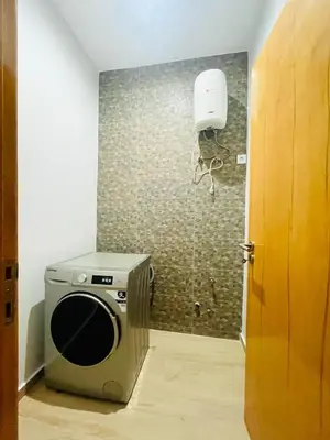 a room with a microwave and a speaker on a wall at Aparthotel DI LIA T3 in Praia