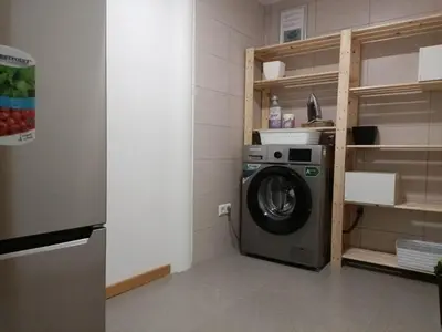 a washing machine in a room with a shelf at mezzanino Ribeira Brava in Vila da Ribeira Brava