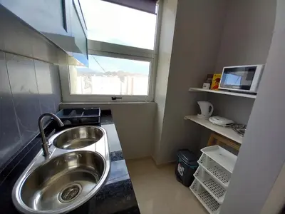 a bathroom with a sink and a window at SILVAs Apartment in Mindelo