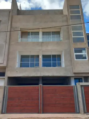 an apartment building with a red garage at SILVAs Apartment in Mindelo
