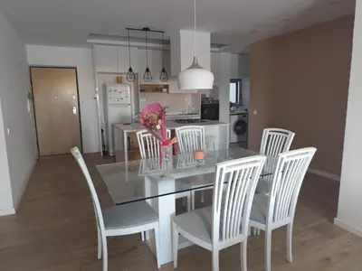 a dining room and kitchen with a table and chairs at Isa Charme Home in Praia
