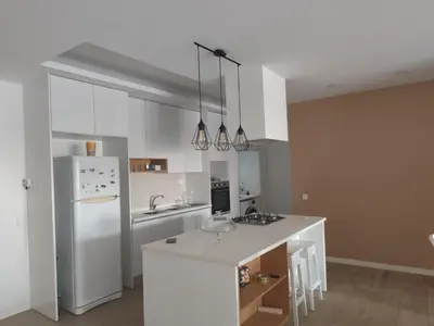 a kitchen with a white refrigerator and a white counter top at Isa Charme Home in Praia