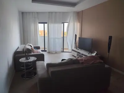 a living room with two couches and a television at Isa Charme Home in Praia