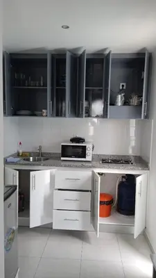 a kitchen with white cabinets and a counter top at CasaMrichica1 in Ribeira Grande