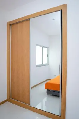 a sliding glass door in a room with a bed at Apartamento das Flores 2 in Praia