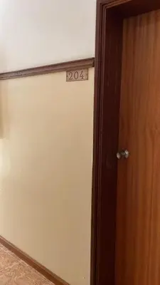 a room with a door with a sign on it at Felicidade Hotel in Praia