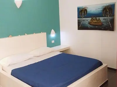 a bedroom with a large bed with a blue blanket at Apartment in Sal Rei - Boa Vista in Sal Rei