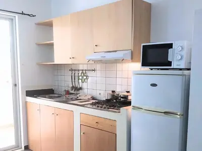 a kitchen with a white refrigerator and a microwave at Apartment in Sal Rei - Boa Vista in Sal Rei
