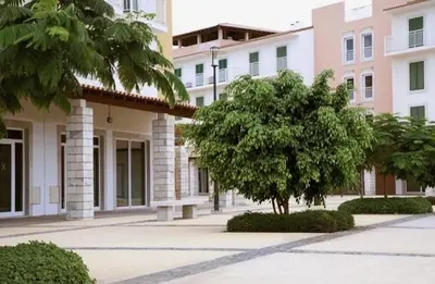 a building with a tree in the middle of a street at Vila Verde - Chez Val in Santa Maria