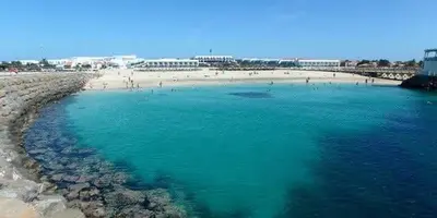 a beach with a group of people in the water at Vila Verde - Chez Val in Santa Maria