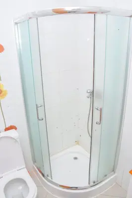 a shower stall in a bathroom with a toilet at Hot belvedere in Praia