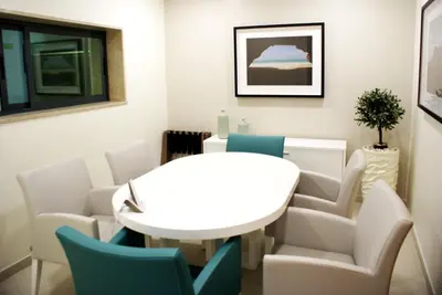 a meeting room with a white table and chairs at Beramar Hotel in Praia