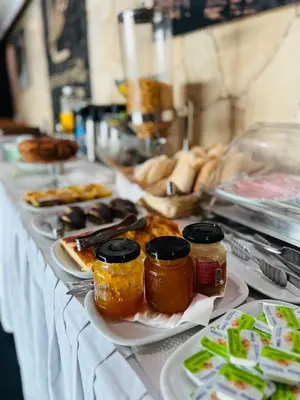 a table with many plates of food on at Beramar Hotel in Praia