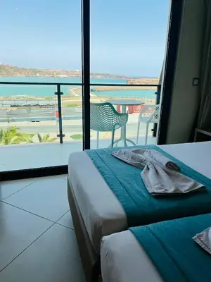 a hotel room with a bed and a view of an airport at Beramar Hotel in Praia