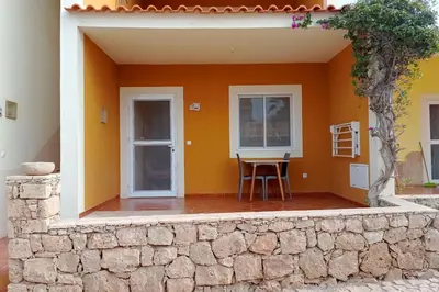 a patio of a house with a table and chairs at Appartamento Ferreira Stella Maris Exclusive in Calheta Do Maio