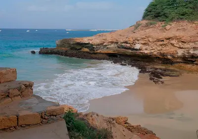 a beach with rocks and the water and the ocean at Appartamento Ferreira Stella Maris Exclusive in Calheta Do Maio