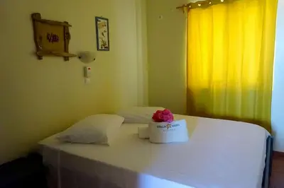 a room with a bed with a flower in a box on it at Appartamento Polvo. Stella Maris Exclusive in Calheta Do Maio