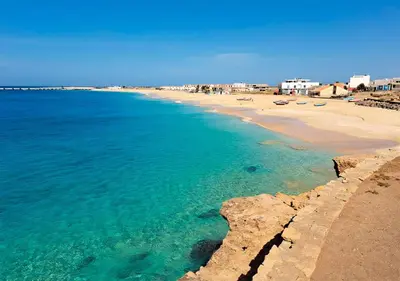 a view of a beach with chairs and the ocean at Appartamento Serra. Stella Maris Exclusive in Calheta Do Maio