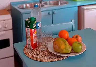 a plate of fruit on a table with a bottle of milk at Appartamento Percebes. Stella Maris Exclusive in Calheta Do Maio