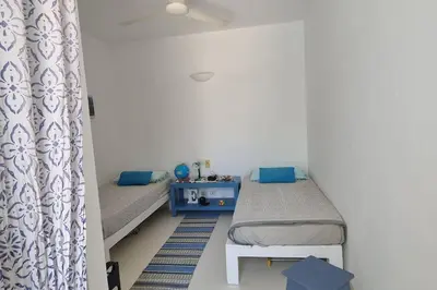 a room with two beds and a curtain at Casa Vida Boa in Sal Rei