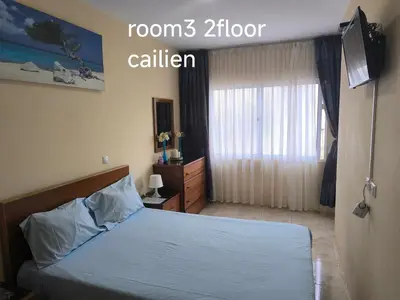 a bedroom with a bed and a television in it at guesthouse emaly in Mindelo