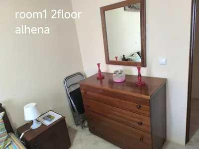 a dresser with a mirror on top of it at guesthouse emaly in Mindelo
