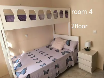 a bedroom with a bed with a bunk bed at guesthouse emaly in Mindelo
