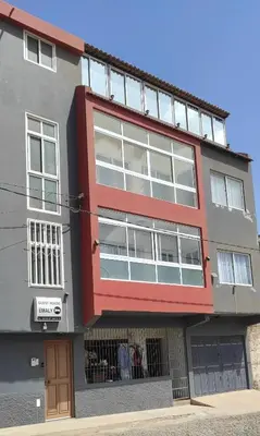 an apartment building with a red and gray at guesthouse emaly in Mindelo