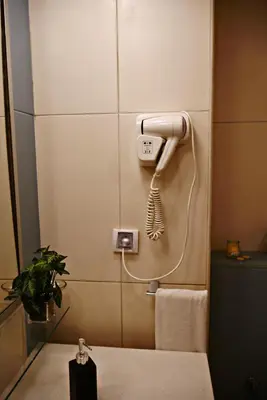 a bathroom with a phone on the wall at Mi Casa és Su Casa in Prainha